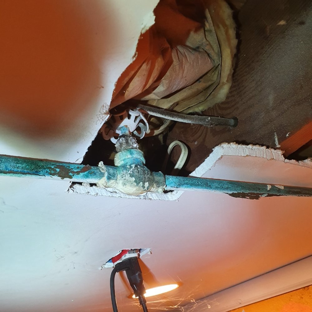 Plumber fixing kitchen faucet